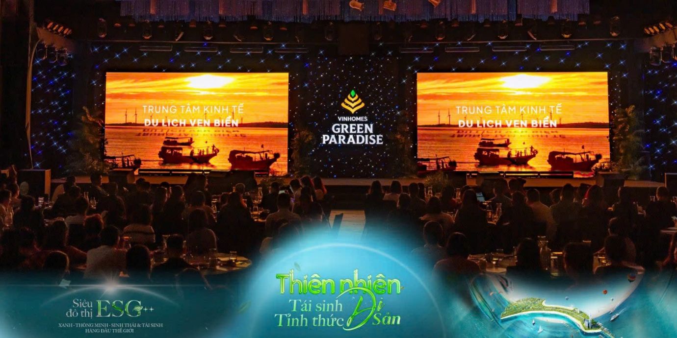 A group of people sitting at tables in front of a large screenAI-generated content may be incorrect.